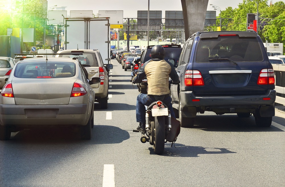 Motorcycle rider lane splitting the highway in Georgia.