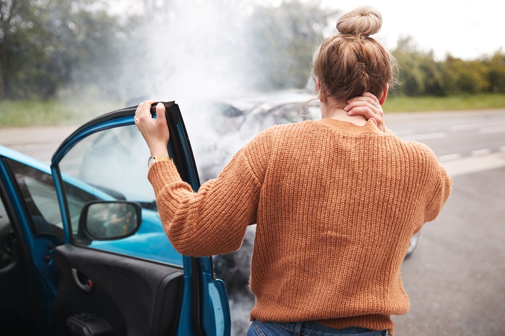 Woman driver experiencing concussion after car accident.