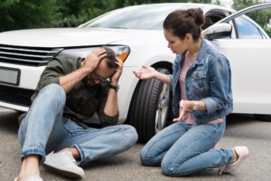 a woman trying to help a man she just hit
