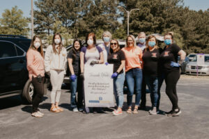 Staff from Highlanders Tavern and Pub holding thank you banner