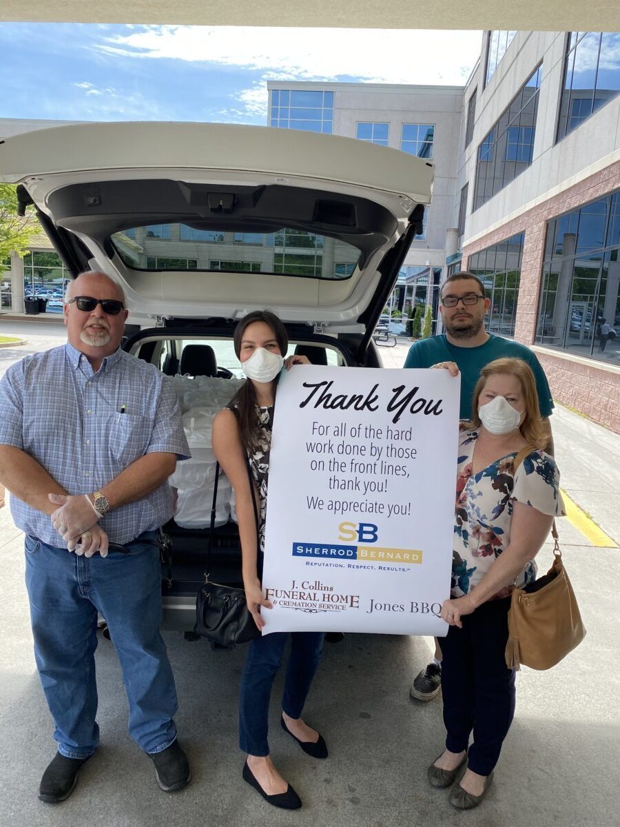 Group of people holding thank you banner