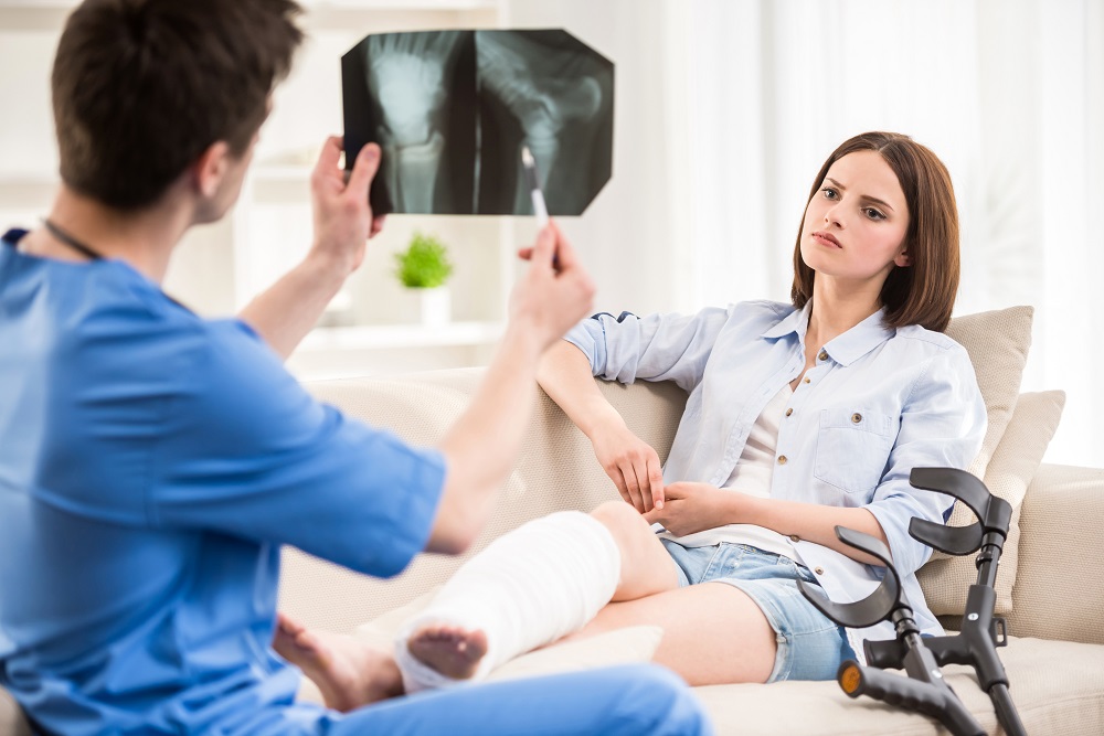 Injured woman doing therapy for her fractured legs.