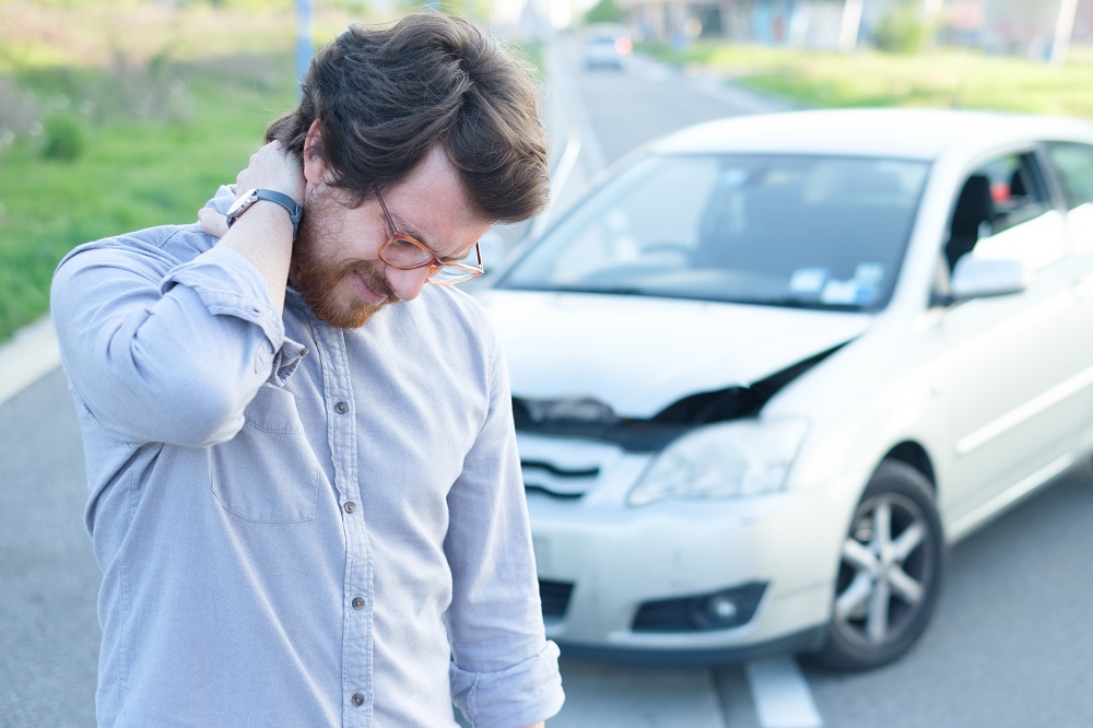 Driver experiencing a whiplash injury after car accident.