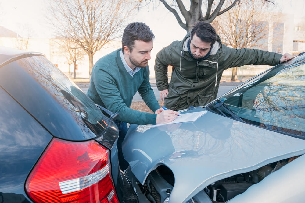 Two drivers exchanging information after a rear-end accident in Georgia.