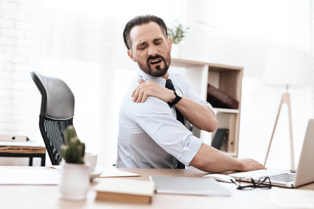 Businessman suffering rotator cuff injury from a car accident in Georgia.