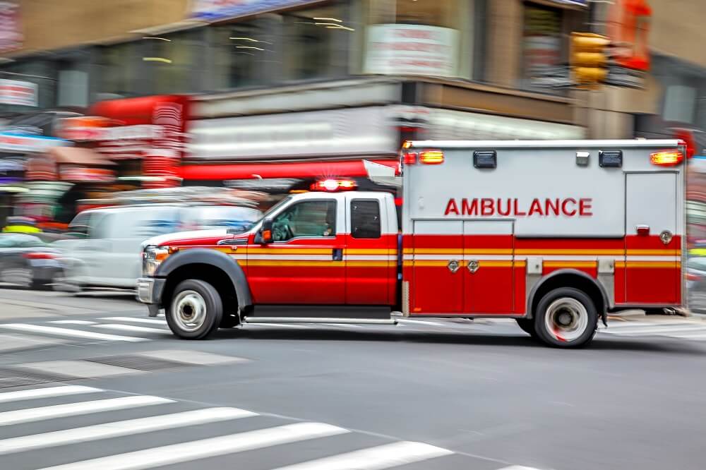 Ambulance passing through the highway.