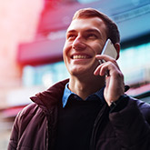 man placing a call to his attorney on his cell phone