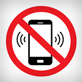 Cellphone with a red circle and line over it.
