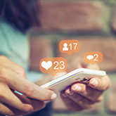 A person receiving updates from social media on their smart phone.