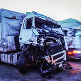 A truck in a junk yard after a truck accident