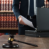 lawyer removing paperwork from his briefcase