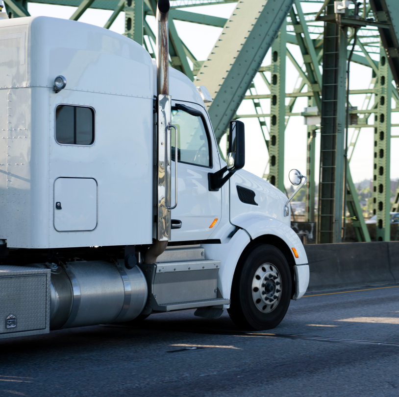 semi truck driving on a bridge