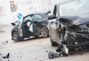 Car collision happening along the highway.