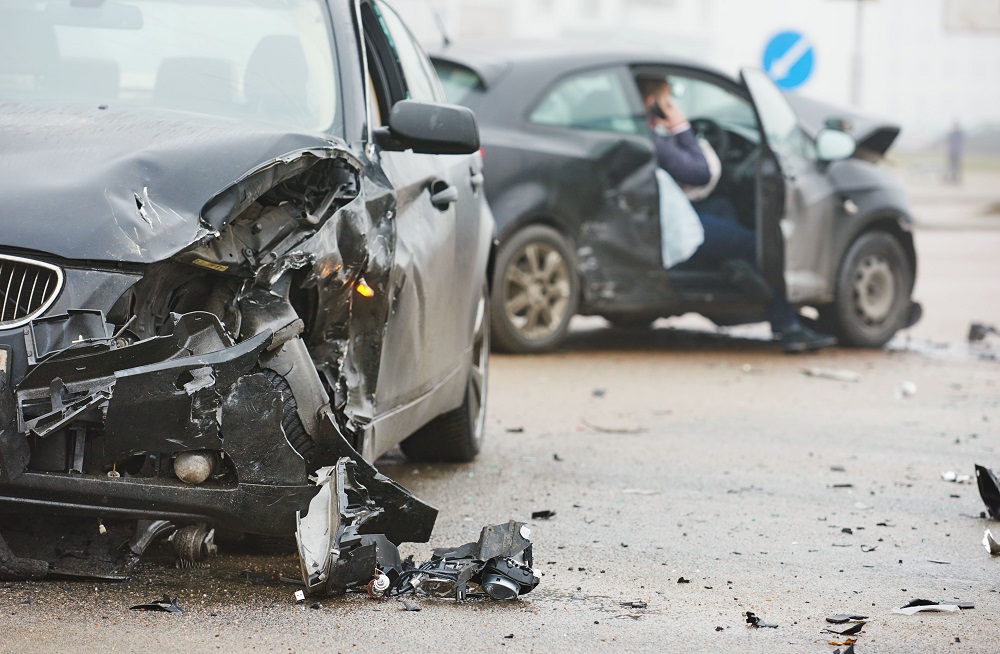 Damaged automobiles after collision in city.