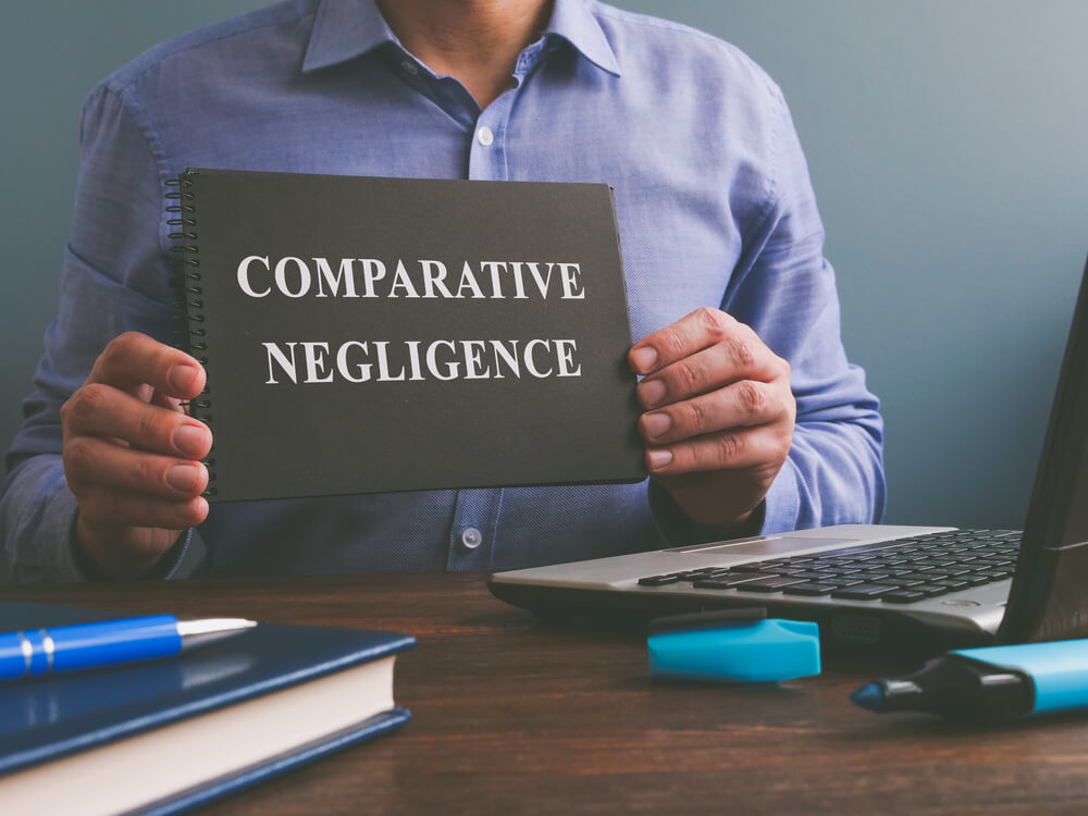 Man holding comparative negligence book.