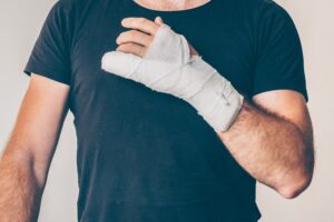 Man showing his injured arm from car accident.