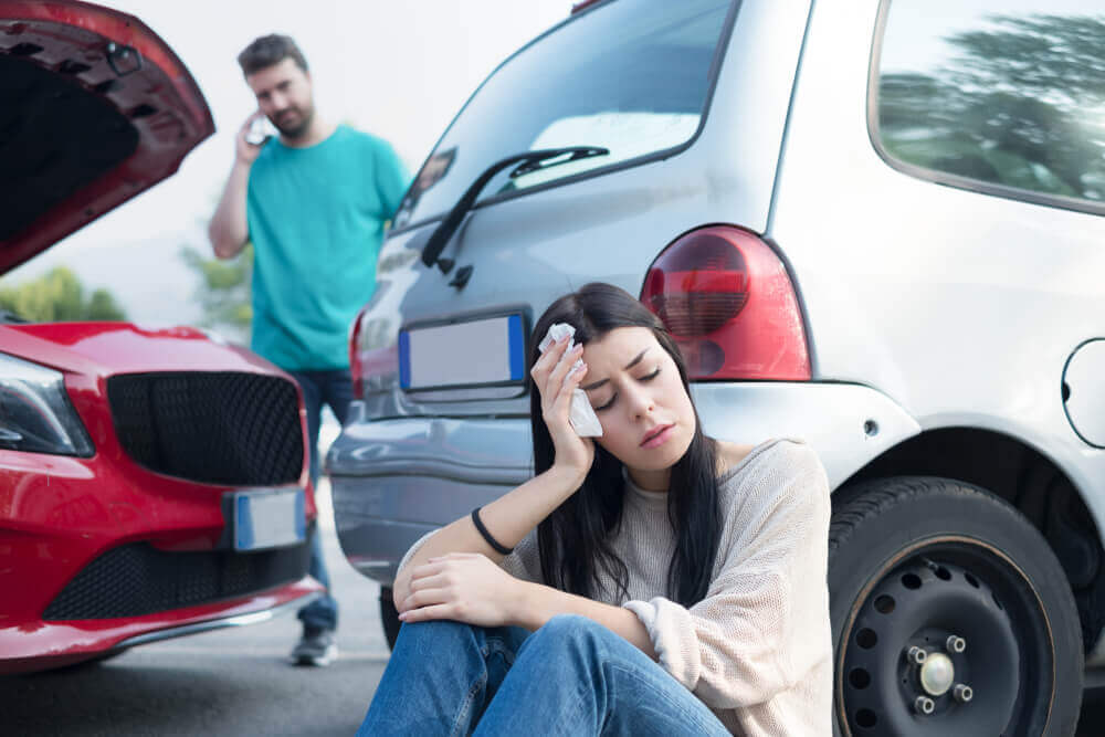 Injured lady driver suffering head injuries from collision.