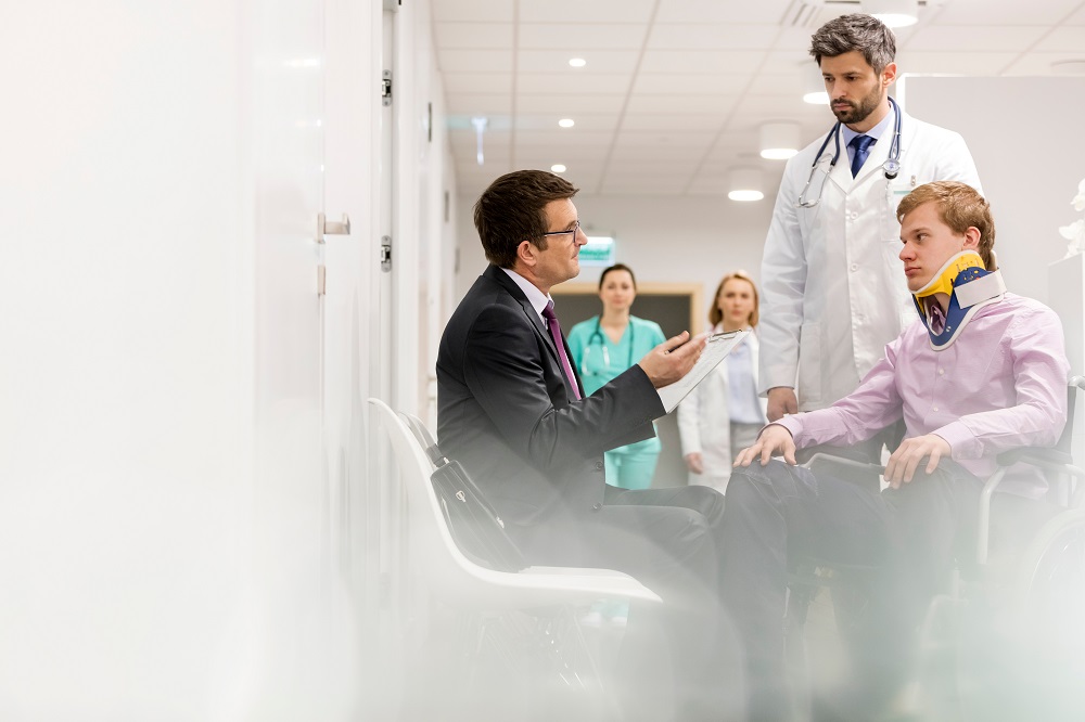 Injured patient talking to his doctor and lawyer.