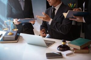 Lawyers having team meeting with law documents.