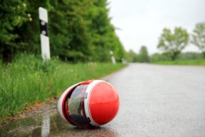 Motorcycle helmet on a wet street.