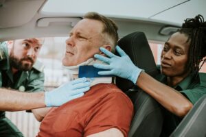 Paramedics rescuing driver from car accident.