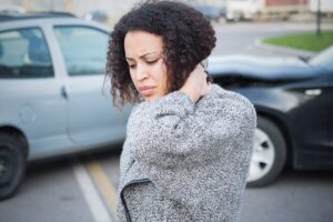 Woman suffering whiplash from accident.