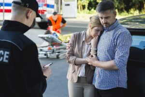 Worried couple interviewed by police officer.
