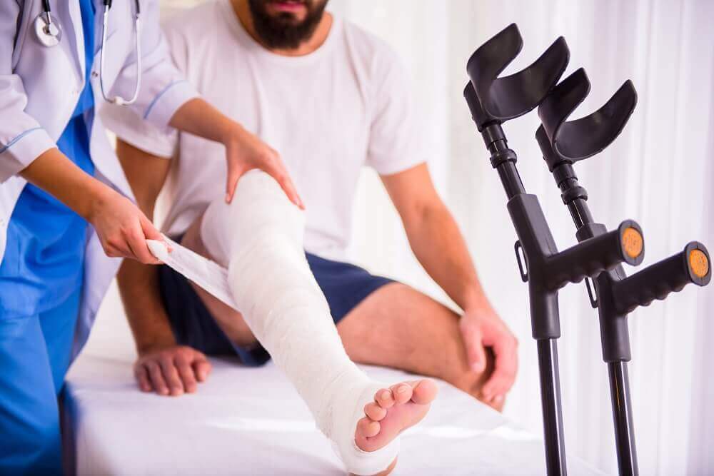 Doctor treating injured man from car accident.