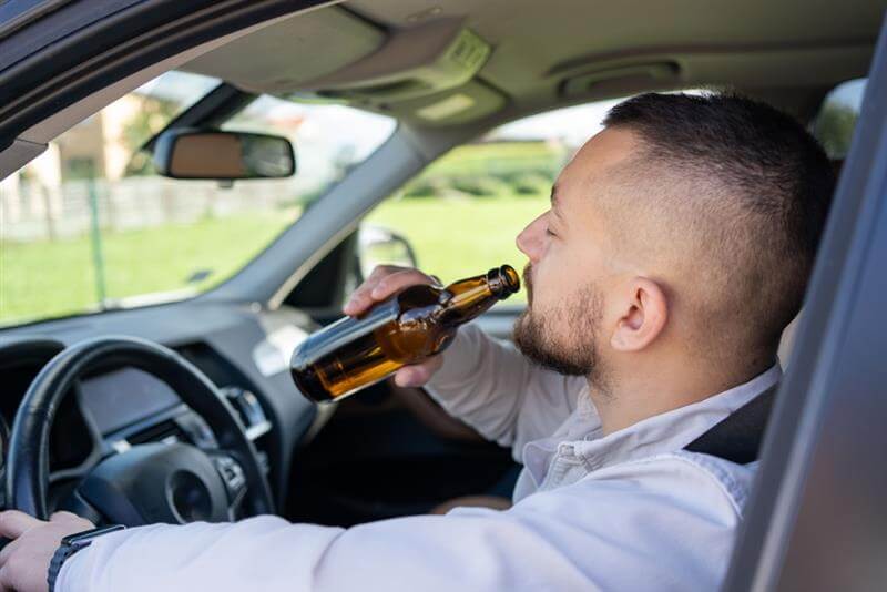 Driver drinking alcohol.