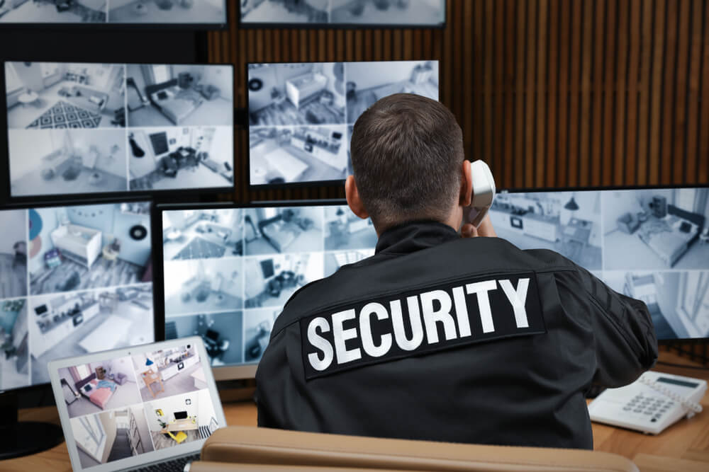 Security personnel monitoring cctv in the building.
