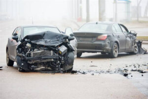 Car crash accident on street with wreck and damaged automobiles after collision.